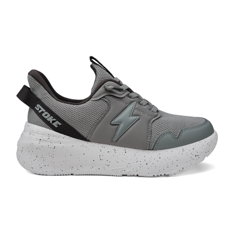 Gray athletic shoe with speckled sole on a white background