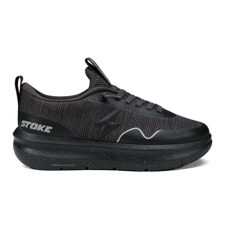 Black athletic shoe with 'STOKE' branding on a white background